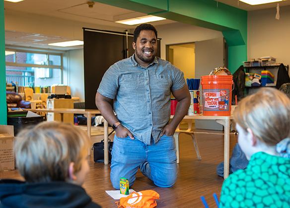 A student teacher works with young children in the classroom